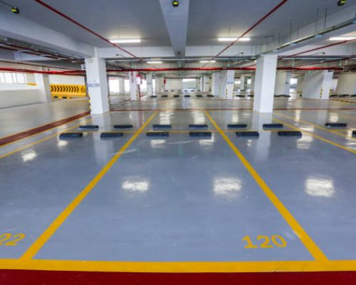 Empty indoor car parking space / lots.