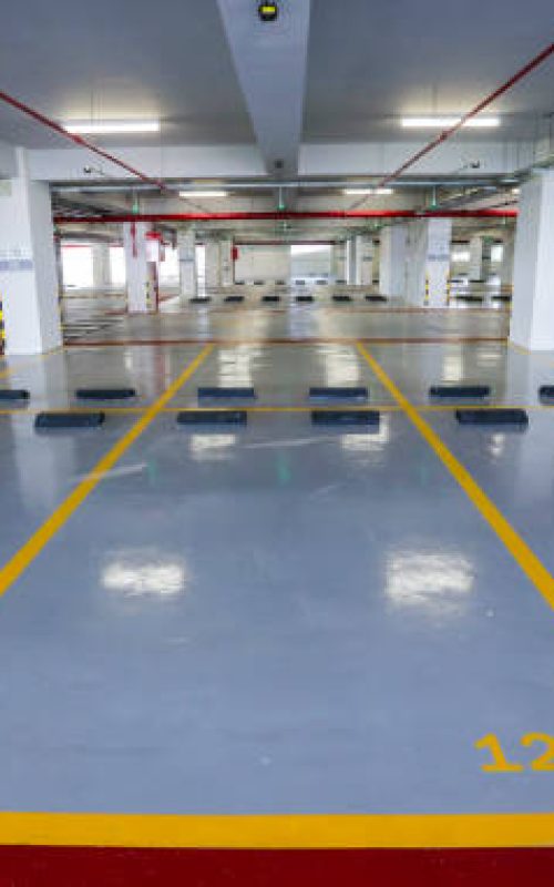 Empty indoor car parking space / lots.